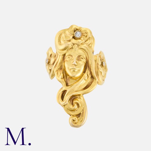 20 - An Art Nouveau Ring in yellow gold, depicting the face of a woman with floral motifs set with diamon... 