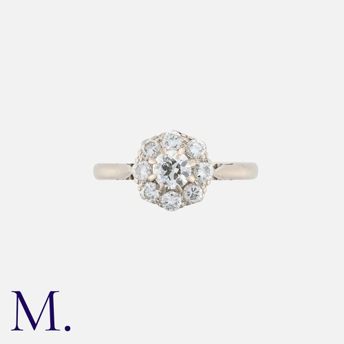 6 - A Diamond Cluster Ring in 18k white gold, comprising a central round cut diamond within a border of ... 