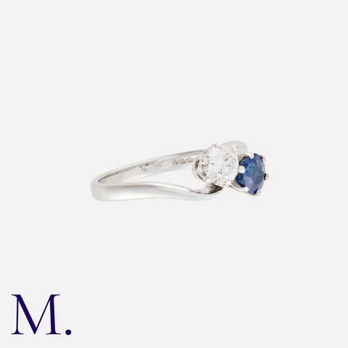 36 - A Sapphire and Diamond Toi et Moi Ring in 18K white gold, set with a round brilliant diamond weighin... 