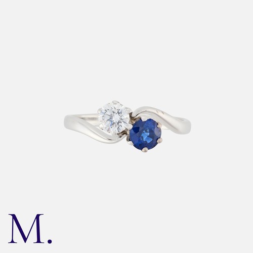 36 - A Sapphire and Diamond Toi et Moi Ring in 18K white gold, set with a round brilliant diamond weighin... 