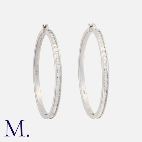 48 - A Pair of Large Diamond Hoop Earrings in 18K white gold set with baguette cut diamonds weighing appr... 