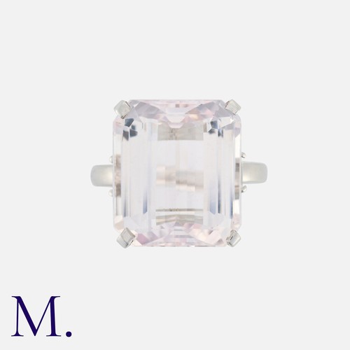 59 - A Kunzite and Diamond Ring in 18K white gold, set with a large emerald-cut kunzite (16x14mm) with em... 