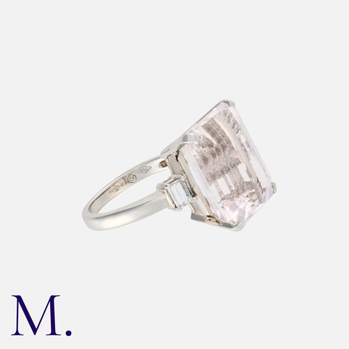 59 - A Kunzite and Diamond Ring in 18K white gold, set with a large emerald-cut kunzite (16x14mm) with em... 