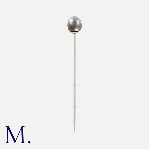 51 - TIFFANY & CO. A Natural Black Pearl Stick Pin in 18k white gold, the terminal set with a button shap... 