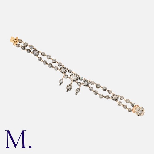 28 - A Rose Cut Diamond Bracelet in yellow gold and silver, comprising two rows of cut-down collet set ro... 