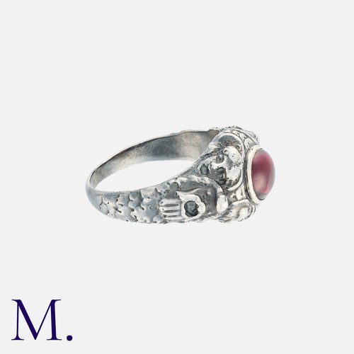 86 - An Antique Garnet Ring in silver, the ornate body set with a cabochon garnet.

Size: Q
Weight: 8.2g.