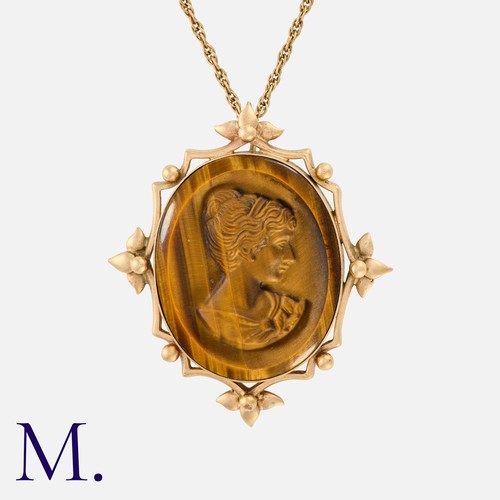 30 - A Tigers Eye Cameo Pendant Necklace in 9k yellow gold, the pendant set with a carved tigers eye came... 