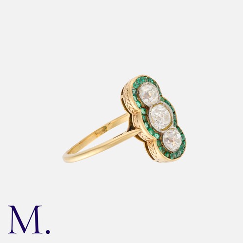 36 - An Emerald and Diamond Ring in 18K yellow gold, set with three old cut diamonds weighing approx. 1.0... 