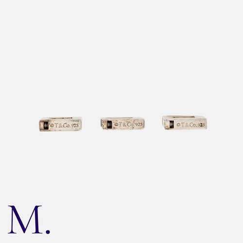 15 - Tiffany & Co, Three Initial Padlock Charms in silver, each comprising an openwork padlock, set to th... 