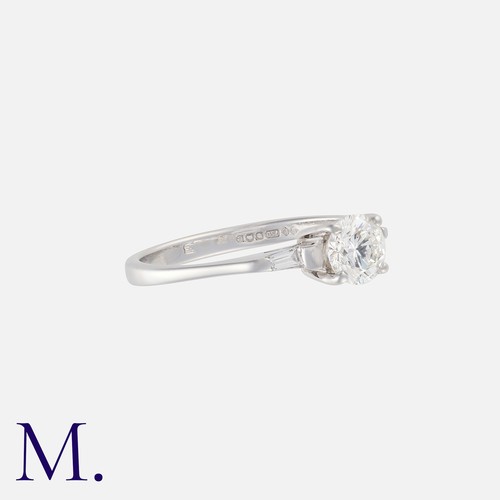 49 - A Diamond Engagement Ring in 18k white gold, set with a principal round cut diamond of approximately... 