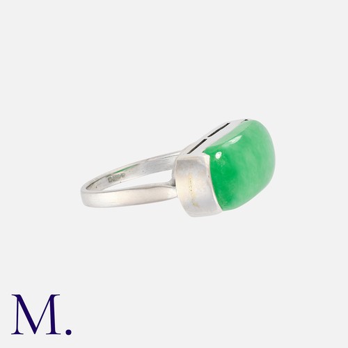 9 - A Jade Ring in 18k white gold, set with a polished piece of jade measuring approximately 21mm X 8.5m... 