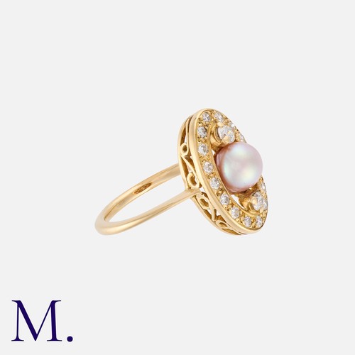 12 - A Pearl And Diamond Ring in yellow gold, set centrally with a round pearl of approximately 5.8mm fla... 