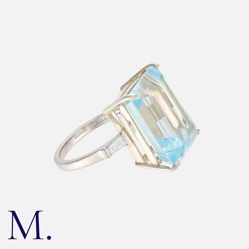 27 - A Topaz And Diamond Ring in 18k white gold, set principally with an octagonal cut blue topaz of appr... 