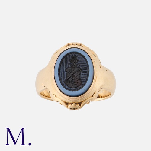 192 - An Agate Signet Ring in yellow gold, set with a carved intaglio banded agate.  Unmarked but tests in... 