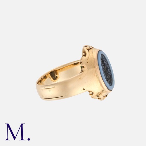 192 - An Agate Signet Ring in yellow gold, set with a carved intaglio banded agate.  Unmarked but tests in... 