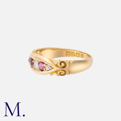 40 - A Ruby And Diamond Five Stone Gypsy Ring in 18k yellow gold, the stylised and set with three round c... 