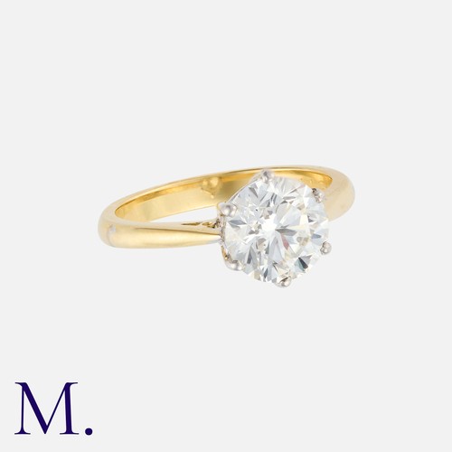 161 - A Diamond Solitaire Ring in 18k yellow gold, set with a principal round cut diamond of approximately... 