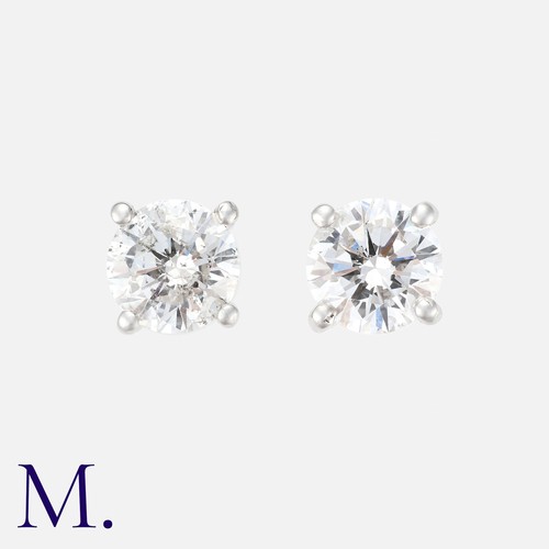 228 - A Pair Of Diamond Stud Earrings in 18k white gold, each set with a round cut diamond of approximatel... 