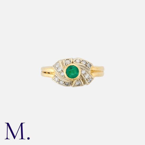 196 - An Emerald and Diamond Ring in 18K yellow gold, set with a round cut emerald to the centre of of whi... 