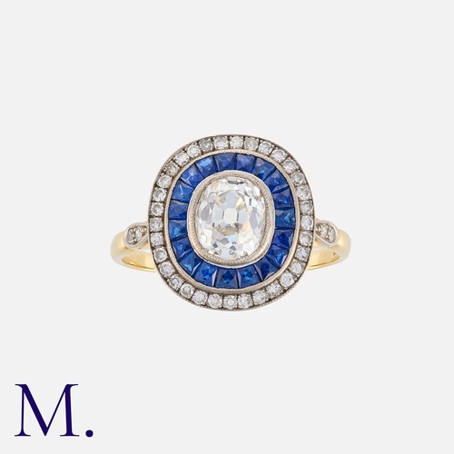 83 - A Sapphire And Diamond Target Ring in 18k yellow gold and platinum, set centrally with an oval shape... 