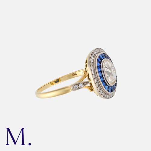 83 - A Sapphire And Diamond Target Ring in 18k yellow gold and platinum, set centrally with an oval shape... 