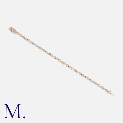 197 - A Diamond Line Bracelet in 9k white gold, comprising a series of interlocking links each set with a ... 