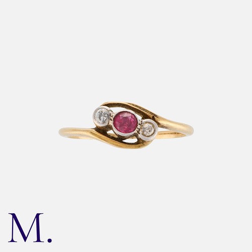 203 - A Ruby And Diamond Three Stone Ring in 18k yellow gold, in crossover design, comprising a round cut ... 