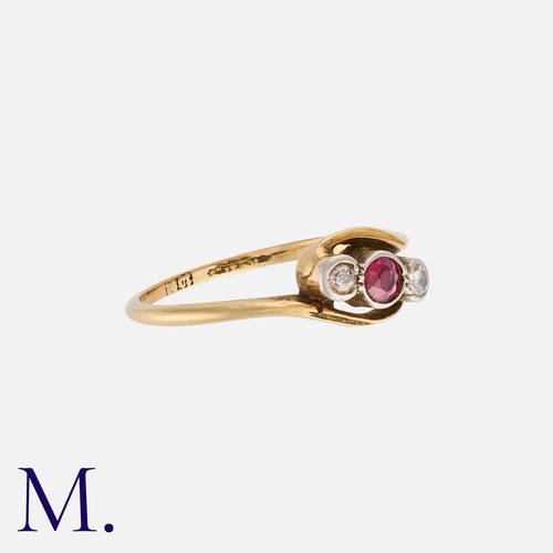 203 - A Ruby And Diamond Three Stone Ring in 18k yellow gold, in crossover design, comprising a round cut ... 