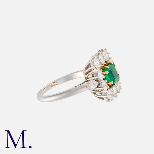 133 - An Emerald and Diamond Ring in 18K white gold, set with a square cut emerald with round cut diamonds... 