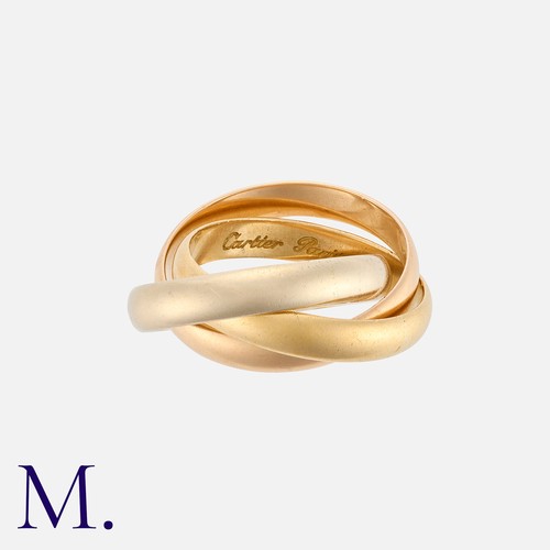 36 - CARTIER. A Trinity Ring with three interlocked bands in 18K yellow, white and rose gold.  Signed Car... 