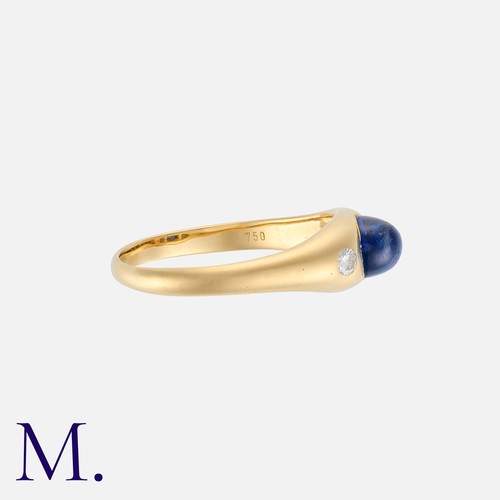 15 - A Sapphire And Diamond Gypsy Ring in 18k yellow gold, set with a tall cabochon sapphire between roun... 