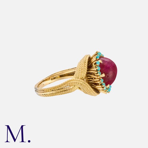 159 - A Ruby and Turquoise Ring in 18K yellow gold set with a cabochon ruby to the centre with cabochon tu... 