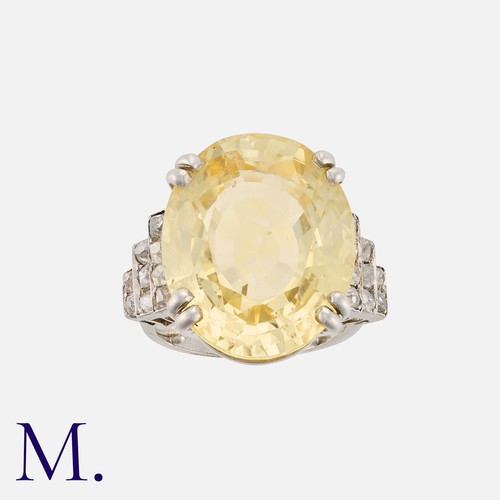 138 - An Impressive Ceylon Yellow Sapphire and Diamond Ring in platinum, set with a large oval-cut sapphir... 