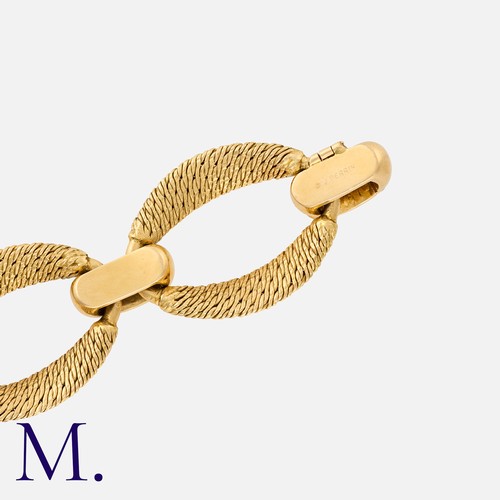 80 - GEORGES LENFANT FOR OJ PERRIN. A Gold Bracelet in 18K yellow gold, with the famous woven-gold oval l... 