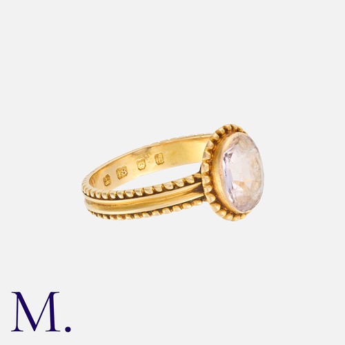 33 - An Antique Pink Topaz Ring in 18K yellow gold.  Set with an oval-cut pink topaz to a beaded setting ... 