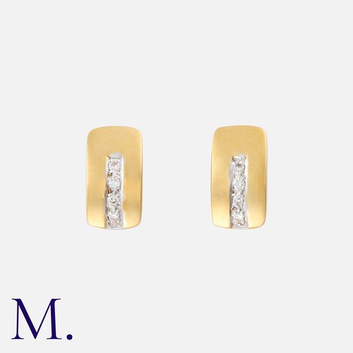 239 - A Pair of Diamond Earrings in huggy style in 18K gold, each set with four round cut diamonds.  Total... 