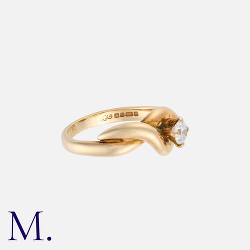 4 - A Diamond Ring in 9K yellow gold, with cross-over style, set with a round cut diamond weighing appro... 