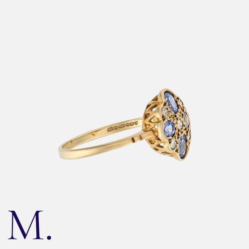 110 - A Sapphire and Diamond Ring in quatrefoil form in 9K gold, set with four cornflower blue sapphires a... 