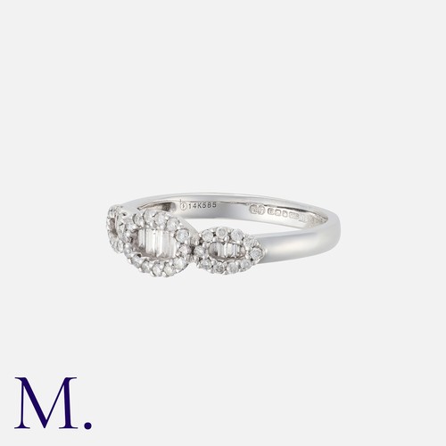 235 - A Diamond Ring in 14K white gold, set with round and tapered baguette cut diamonds weighing approx. ... 