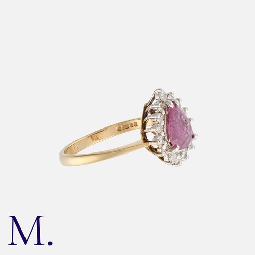 32 - A Pink Sapphire and Diamond Ring in 9K gold, set with a pear-cut pink sapphire and 15 round cut diam... 