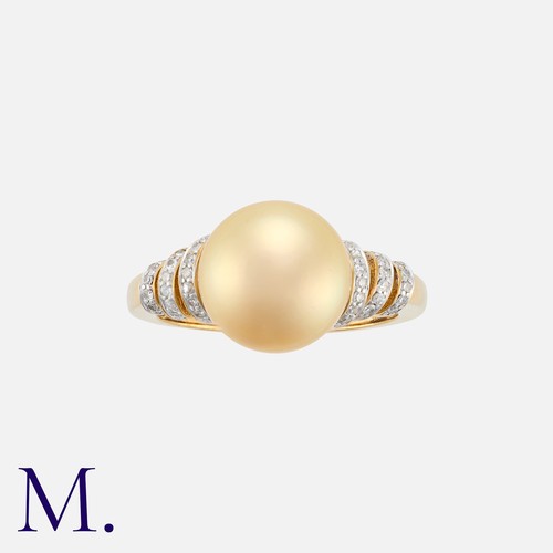 199 - A Pearl and Diamond Ring in 9K yellow gold.  Set with a golden-hued cultured button pearl (approx. 1... 