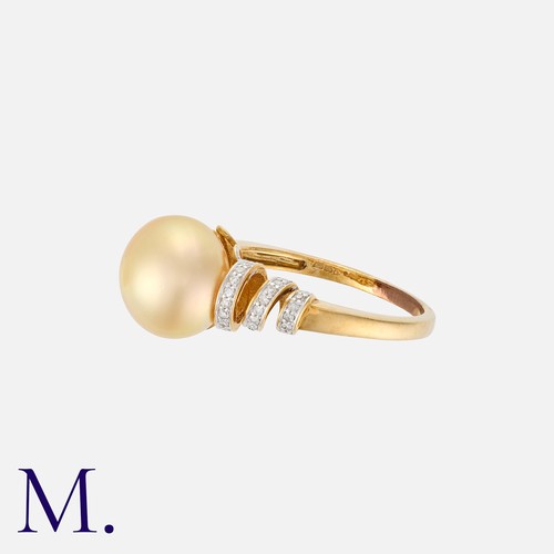 199 - A Pearl and Diamond Ring in 9K yellow gold.  Set with a golden-hued cultured button pearl (approx. 1... 