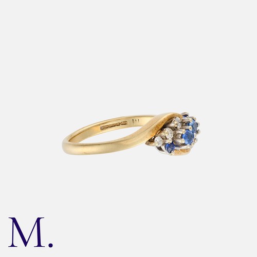 118 - A Sapphire and Diamond Ring in cross-over style in 9K gold, set with four round cut sapphires to the... 