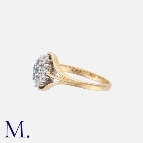 17 - An Aquamarine and Diamond Ring in 9K gold, set with four round cut aquamarines to the centre with fo... 