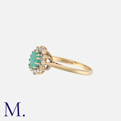 177 - An Emerald and Diamond Ring in 9K yellow gold, set with an oval-cut emerald to the centre with twelv... 