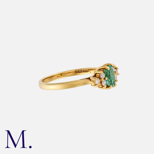 5 - An Emerald & Diamond Ring in 18K yellow gold with an oval cut emerald to the centre with three round... 