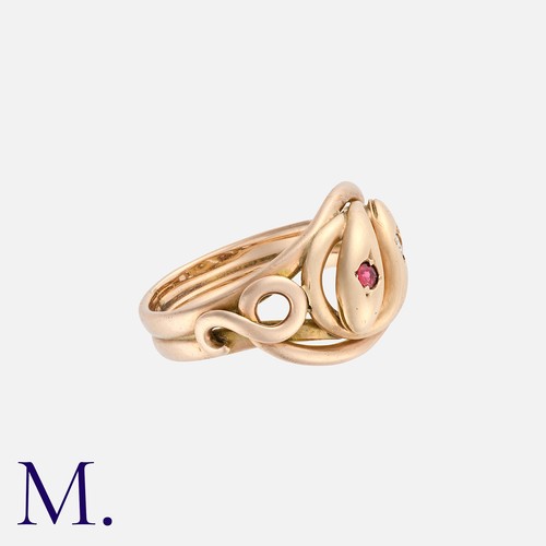 19 - A Spinel And Diamond Snake Ring in yellow gold, designed as two coiled snakes, one head set with a r... 