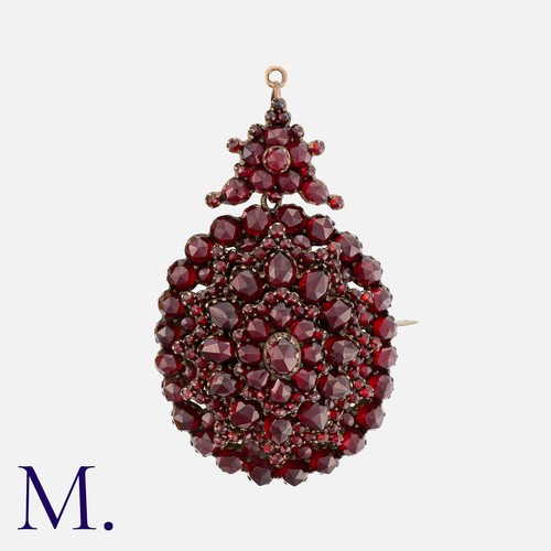 224 - A Garnet Brooch / Pendant comprising a cluster of rose cut garnets with detachable bail and locket b... 