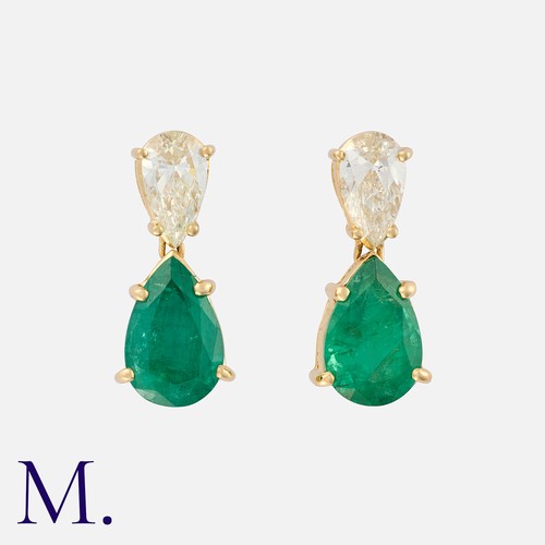 61 - A Pair Of Emerald And Diamond Drop Earrings in 18k yellow gold, each comprising a pear shaped diamon... 