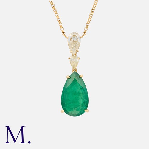 62 - An Emerald And Diamond Pendant in 18k yellow gold, comprising a two pear shaped diamonds, one weight... 